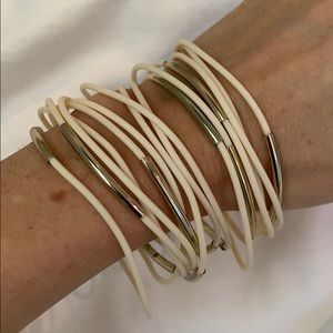Stack of ivory and gold bracelets